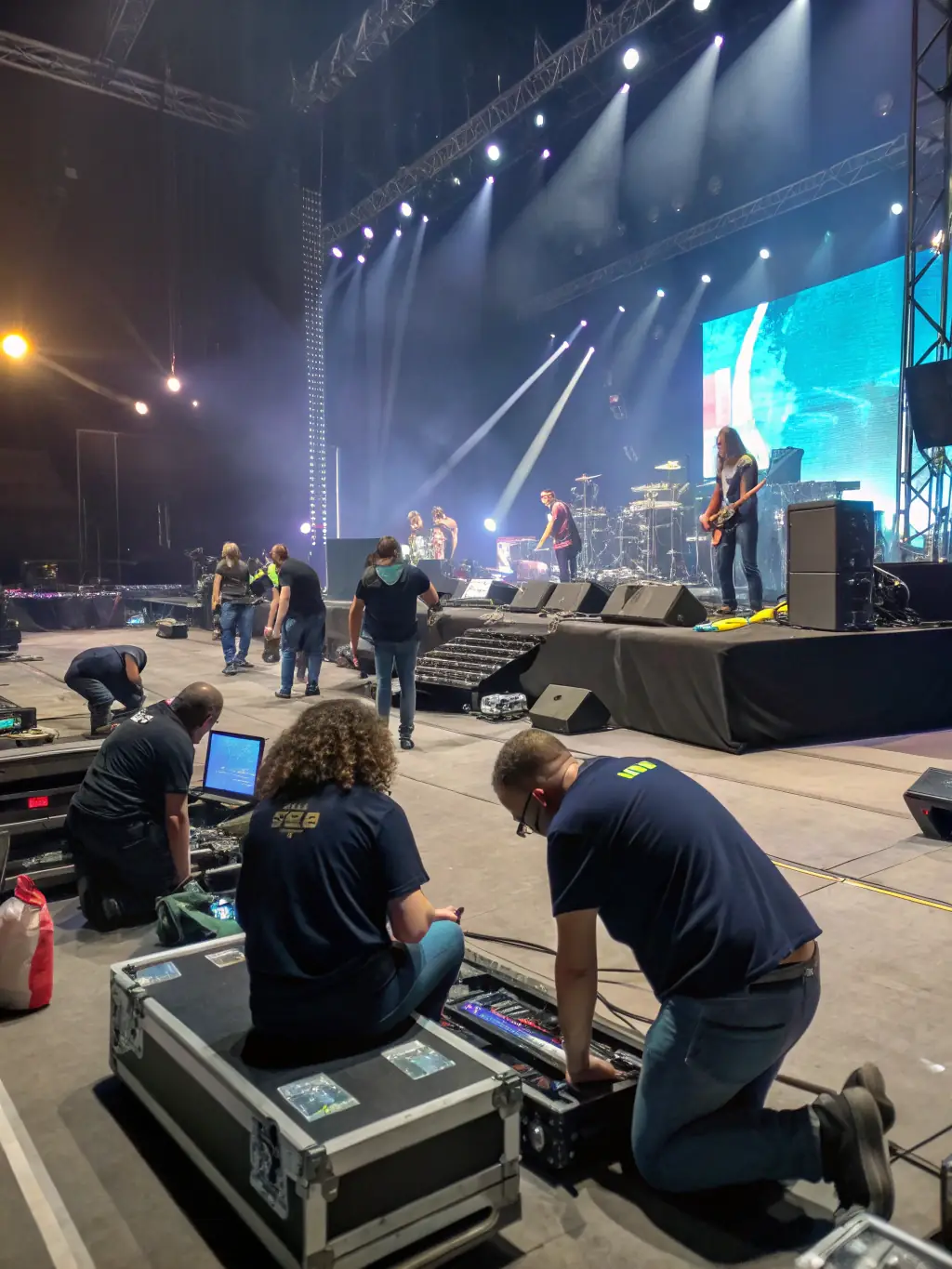 A vibrant photograph capturing volunteers assisting at a local theater performance, showcasing LES AMIS DES LEGENDES' support for cultural events.